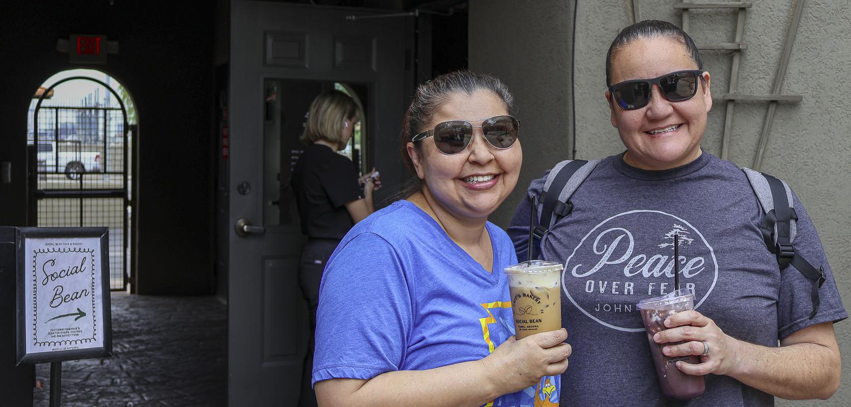 Cheers to coffee and good company! Guests enjoy refreshing iced drinks outside Social Bean Café & Bakery at the Husband & Wife Law Team’s HEART event.