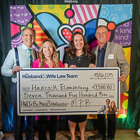 Mark and Alexis Breyer presenting the Be Kind Award check to Hancock Elementary School