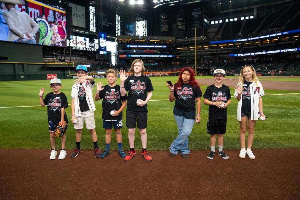 Excitement filled the air as Kids Take the Field participants smiled, waved, and took in the thrill of standing on Chase Field before the game.
